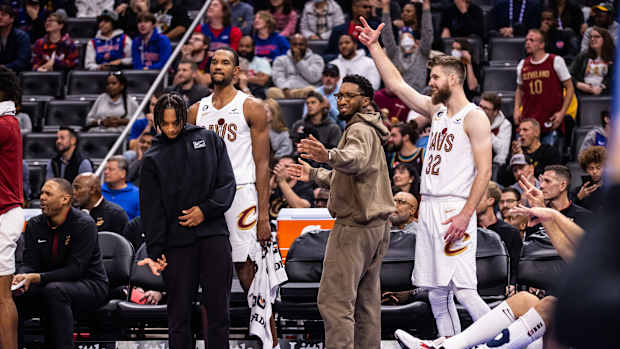 Cleveland Cavaliers guard Darius Garland (10), forward Evan Mobley (4), guard Donovan Mitchell (45) and forward Dean Wade (32) celebrate a made 3-pointer by Cleveland Cavaliers forward Kevin Love (not pictured) against the Detroit Pistons in the second quarter at Little Caesars Arena.